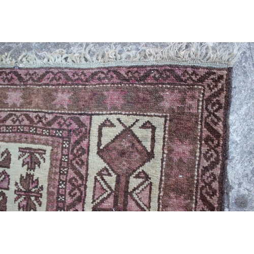 542 - A Middle Eastern prayer rug with geometric designs and star design borders, in shades of natural pin... 