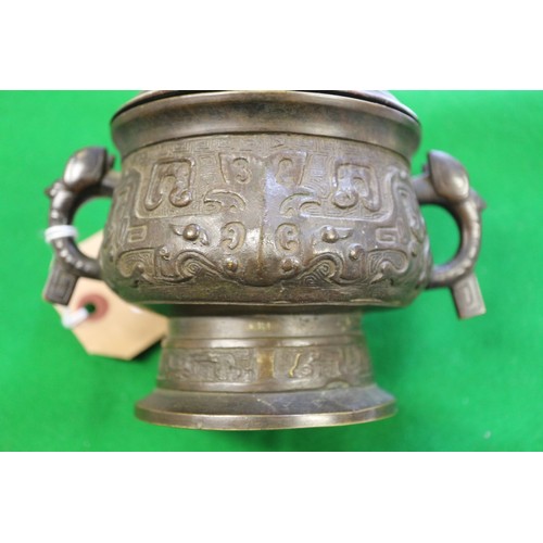 91 - A Chinese brass two-handled censer or archaic design with carved hardwood cover, six-character mark ... 