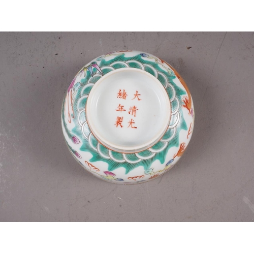 74 - A Chinese porcelain phoenix and dragon decorated bowl with six-character mark, 4 1/2