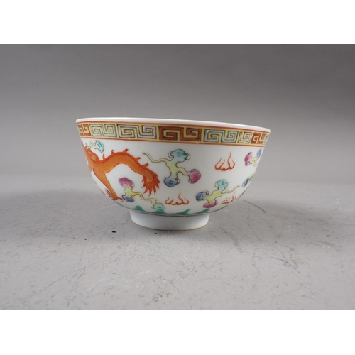 74 - A Chinese porcelain phoenix and dragon decorated bowl with six-character mark, 4 1/2