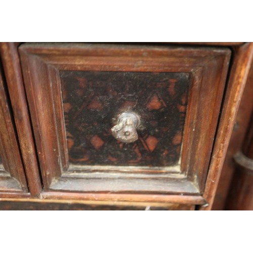 402 - An 18th century Continental walnut and decorated cabinet of drawers, with pull out central cupboard ... 