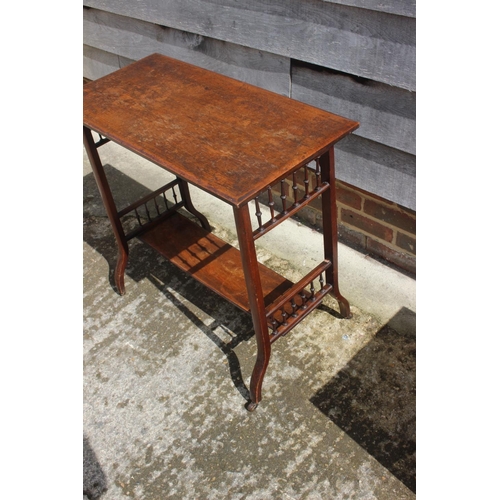 476 - An early 20th century walnut two-tier occasional table, on castored splay supports, 30