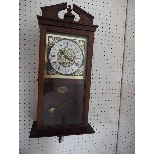 121 - A polished as mahogany regulator style wall clock with shaped pediment and eight-day striking moveme... 