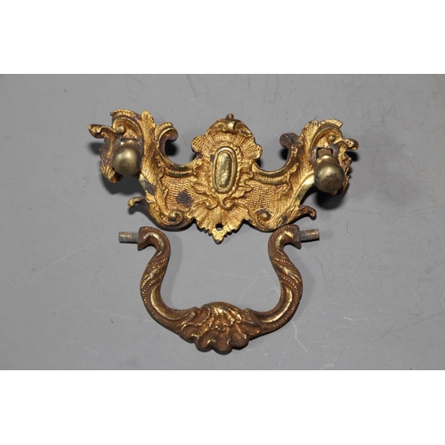 128 - A set of eight mid 18th century ormolu rococo scrollwork handles and back plates with pillars, 2.1