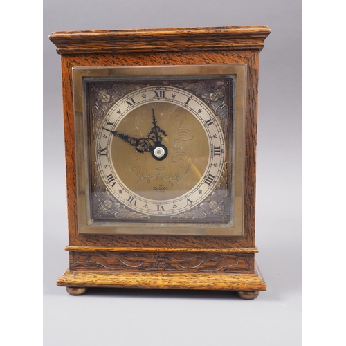 113 - An Elliot oak cased mantel clock with engraved brass dial, 7