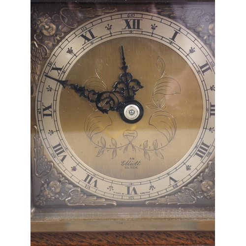 113 - An Elliot oak cased mantel clock with engraved brass dial, 7