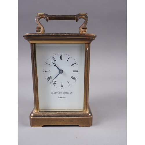 126 - A Matthew Norman brass cased carriage clock with white enamel dial and Roman numerals, 4 3/4