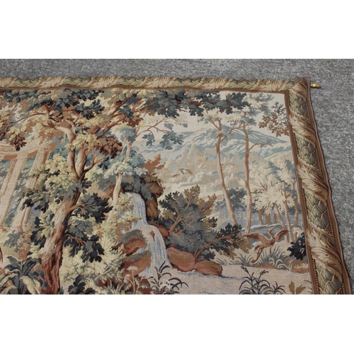 175 - A  Jacquard woven verdure tapestry wall hanging, decorated classical ruins in woodland, 65