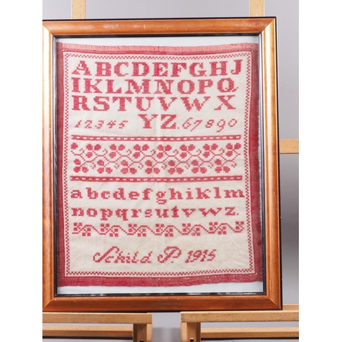 183 - An early 20th century cross stitch alphabet sampler, 18