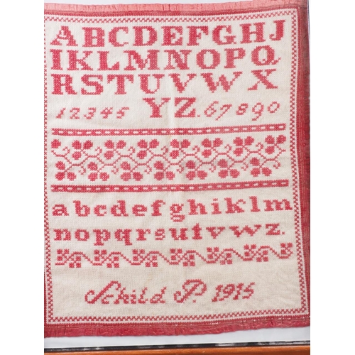 183 - An early 20th century cross stitch alphabet sampler, 18