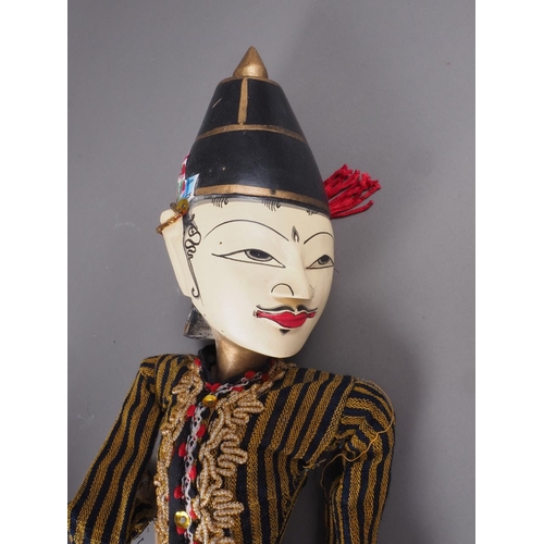 195 - A pair of Javanese carved and painted wooden puppets, 21