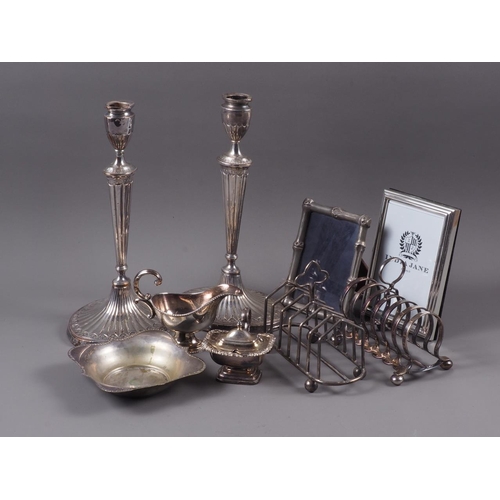 226 - A pair of silver plated oval and fluted candlesticks, 11 3/4