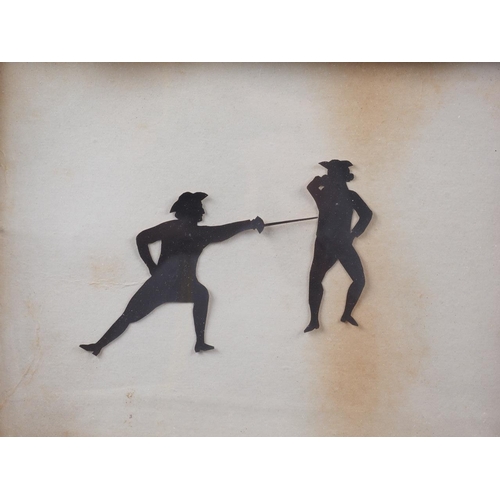 294 - An early 19th century cut paper silhouette, figures fencing, in oak strip frame