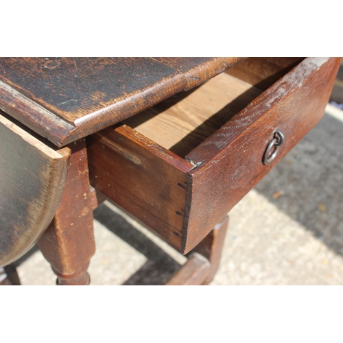 395 - An 18th century oak gate leg table, on turned supports, 41