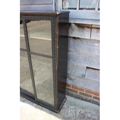 398 - A late 19th century ebonised and glazed two door display cabinet, 31