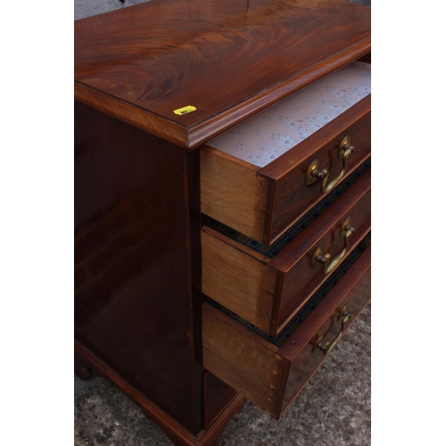 422 - A Georgian style figured mahogany chest of four long graduated drawers, on bracket supports, 24