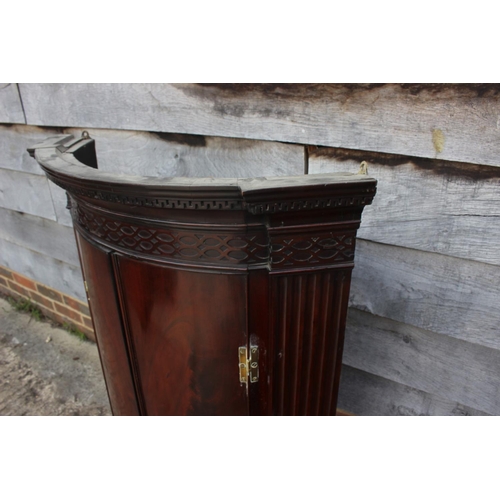 425 - A 19th century figured mahogany and inlaid bowfront hanging corner cupboard with dentil cornice and ... 