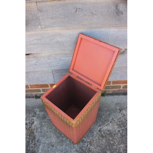 468 - A 1936 Lloyd Loom linen basket, in original pink and gilt spray finish