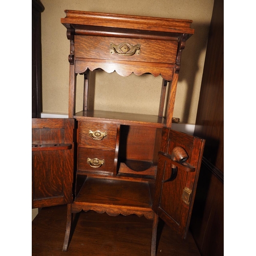 480 - A smoker's Arts & Crafts carved oak side cabinet with tray top over one drawer and fitted interior e... 