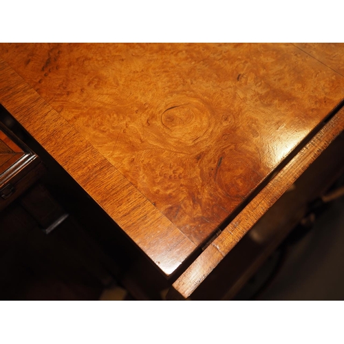 481 - A faded burr walnut and banded sofa table, on panel end splay supports, 54