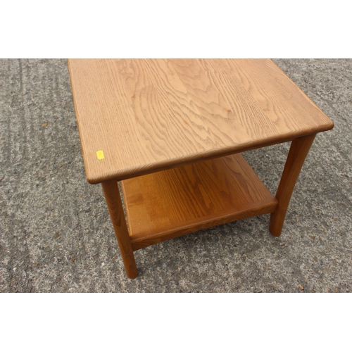 490 - An Ercol ash two-tier coffee table, on shaped supports, 36 1/2