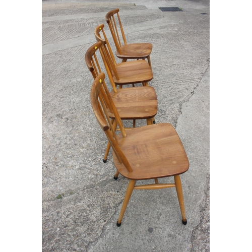 493 - A set of four Ercol 449 beech and elm bow and spindle back dining chairs, on turned and stretchered ... 