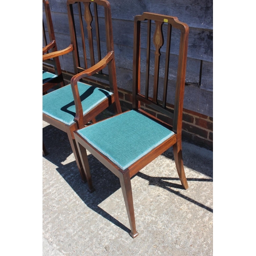 497 - A set of four Edwardian walnut and inlaid vertical rail back dining chairs with padded seats, on squ... 