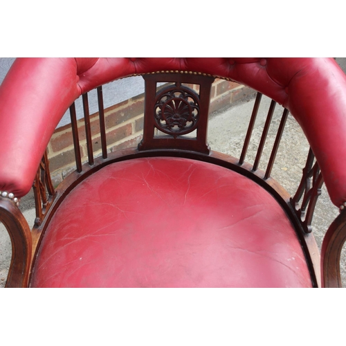 498 - An oak and red studded leather tub chair with pierced splats, fluted supports and crinoline stretche... 