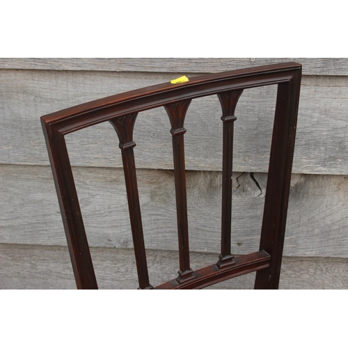 503 - An Edwardian walnut deportment chair with caned back and seat, on stretchered splayed supports, and ... 