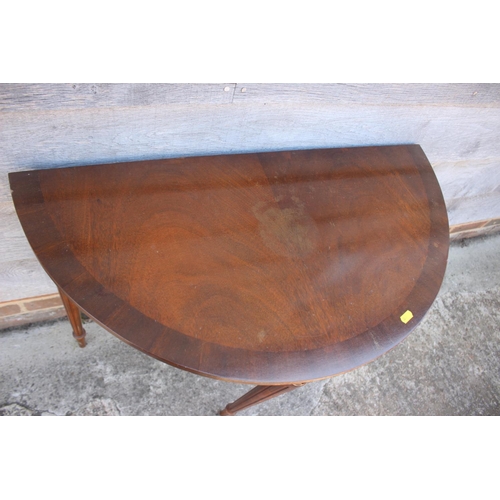 512 - A mahogany 'D' shaped console table, 29