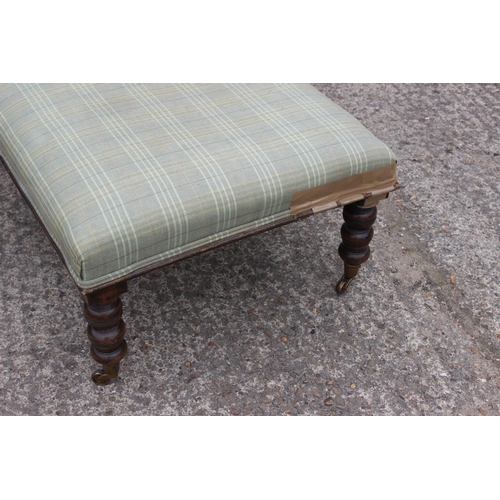 516 - A low stool, upholstered in a check fabric, on turned supports, 37