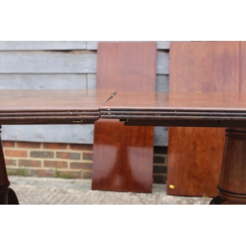 519 - A mahogany double pedestal dining table of Georgian design with two extra leaves, 144