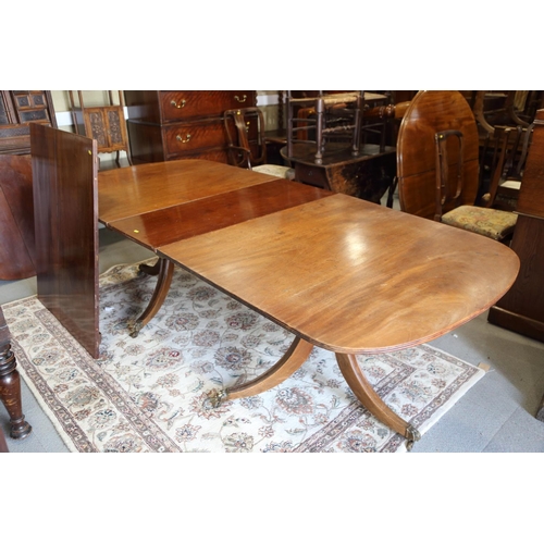 519 - A mahogany double pedestal dining table of Georgian design with two extra leaves, 144