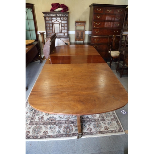 519 - A mahogany double pedestal dining table of Georgian design with two extra leaves, 144