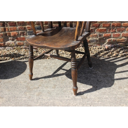 530 - A lath back kitchen chair with elm panel seat, on turned supports