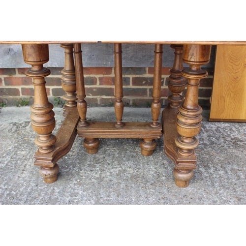 544 - A French light oak extending dining table with two extra leaves, on turned supports and shaped base,... 