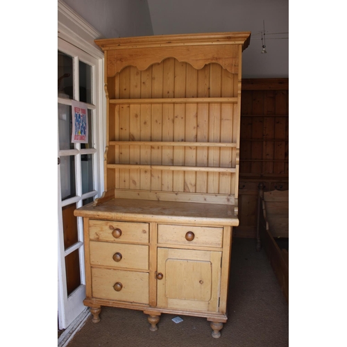 546 - A waxed pine dresser, fitted shelves over four drawers and cupboard, 42