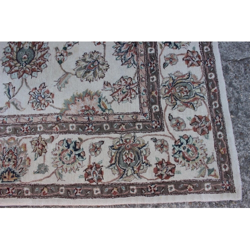 554 - A John Lewis floral decorated rug on a natural ground, 96