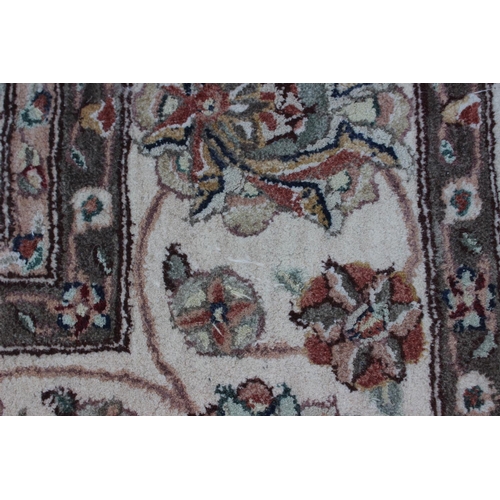 554 - A John Lewis floral decorated rug on a natural ground, 96