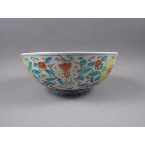 60 - A Chinese porcelain bowl with central decoration of a mythical beast and foliate borders, 11