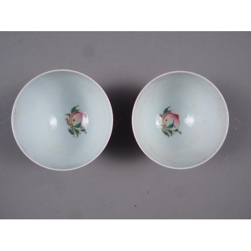 70 - A pair of Chinese pink glazed tea bowls with interior peach decoration, 2