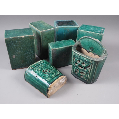 79 - A pair of Chinese green glazed wall pockets with pierced and character decoration, 7 1/2