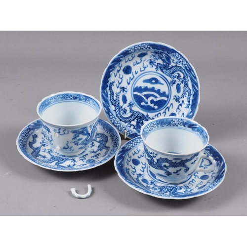 82 - A pair of Chinese blue and white saucers, decorated with sea, dragons and flaming pearl, four-charac... 