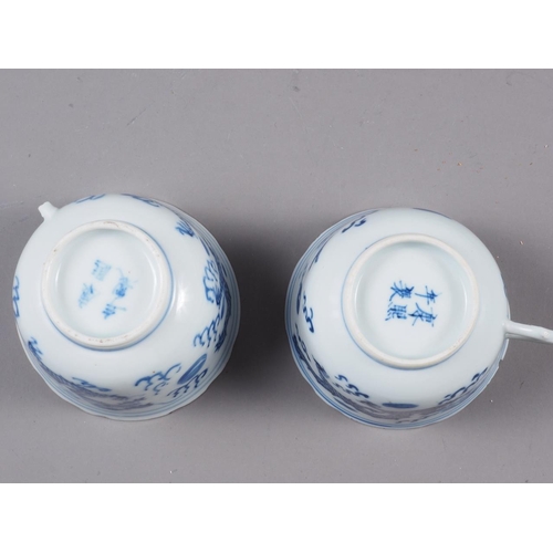 82 - A pair of Chinese blue and white saucers, decorated with sea, dragons and flaming pearl, four-charac... 