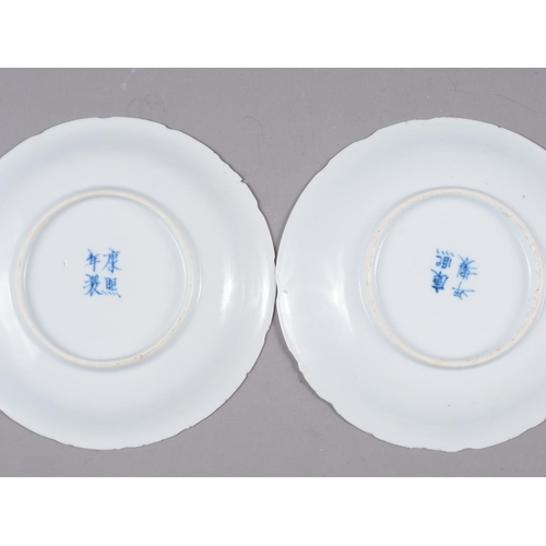 82 - A pair of Chinese blue and white saucers, decorated with sea, dragons and flaming pearl, four-charac... 