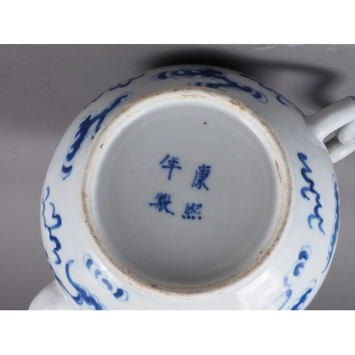 83 - A Chinese blue and white ovoid teapot with associated lid, dragon and cloud decoration, four-charact... 