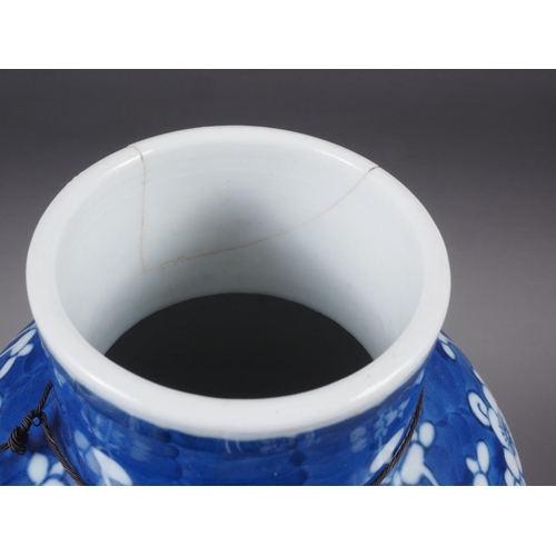 88 - A Chinese blue and white baluster vase and cover, decorated prunus, double ring mark to base, 14