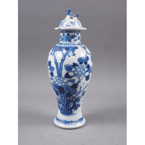 89 - A Chinese blue and white baluster vase and cover with tree and foliage decoration and Dog of Fo fini... 