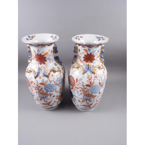 91 - A pair of Chinese Imari palette baluster vases with flower and leaf decoration and applied mythical ... 