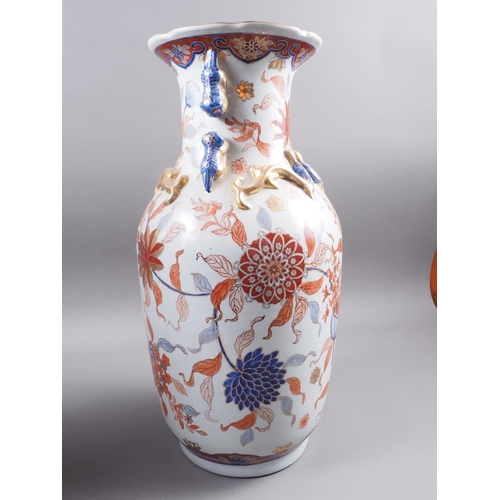 91 - A pair of Chinese Imari palette baluster vases with flower and leaf decoration and applied mythical ... 